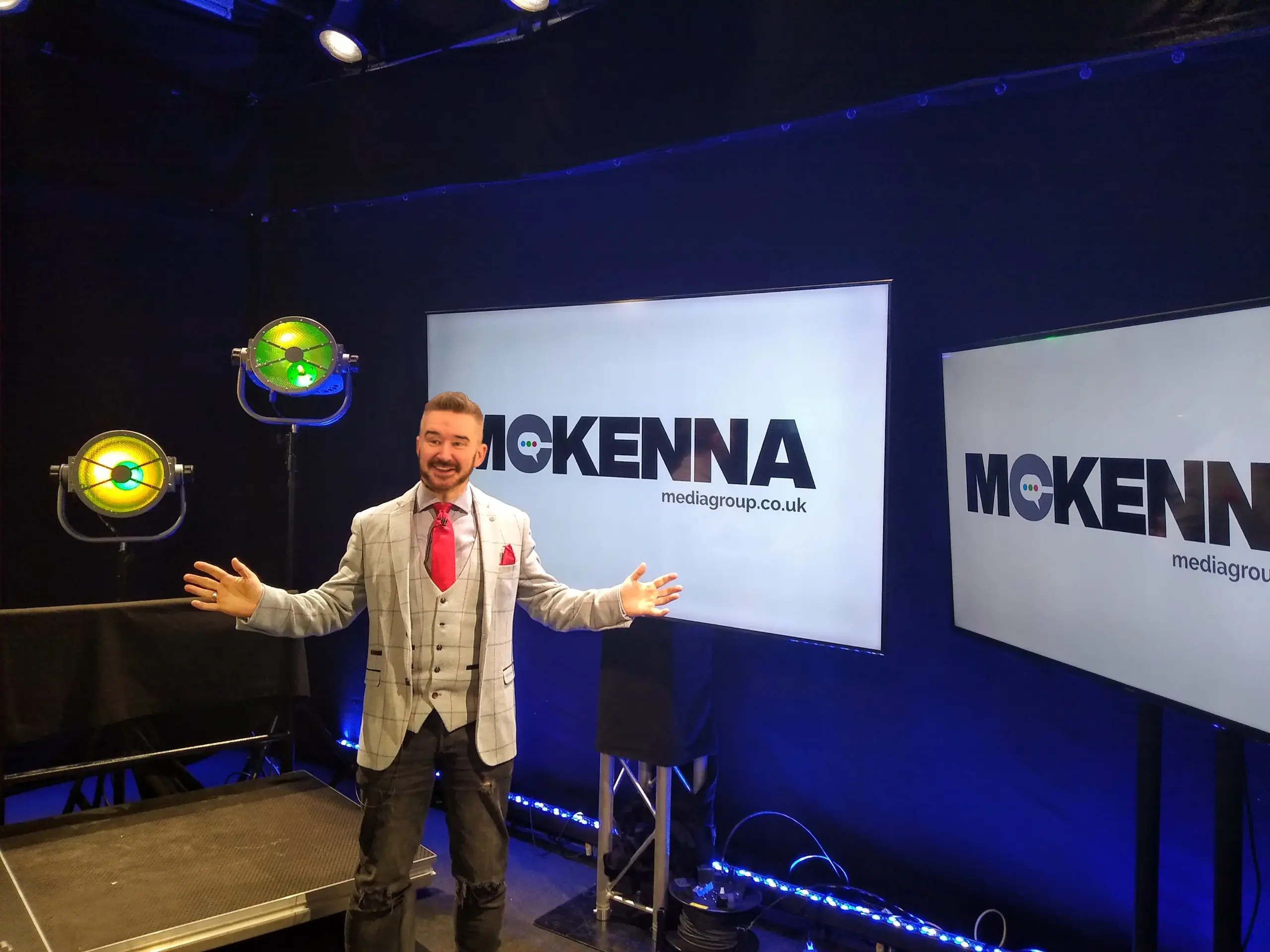 Steve McKenna beside branded screens